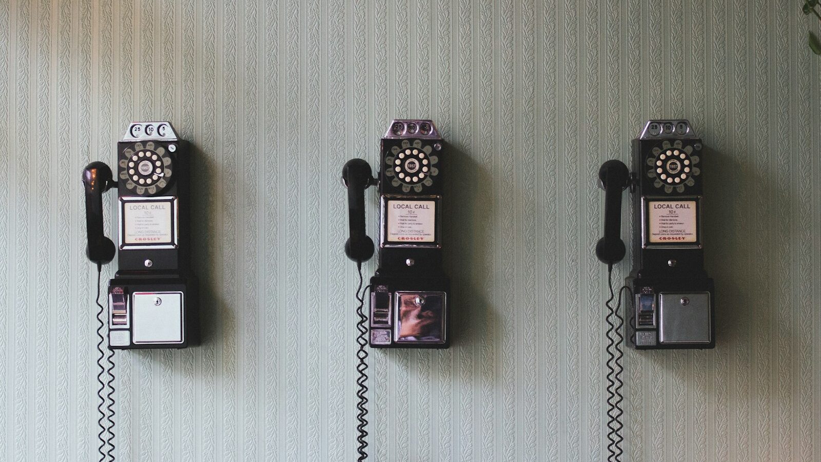 minimalist photography of three crank phones