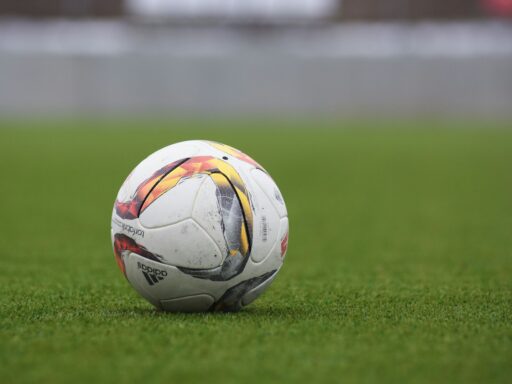 white and gray Adidas soccerball on lawn grass