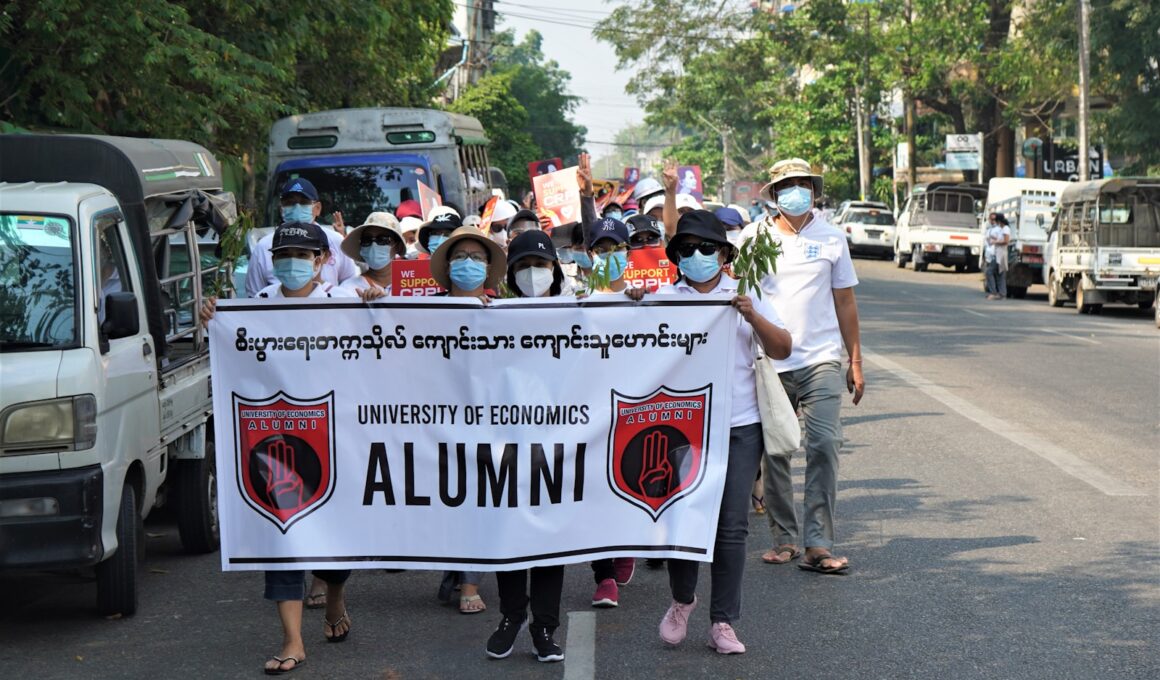 people holding white banner during daytime
